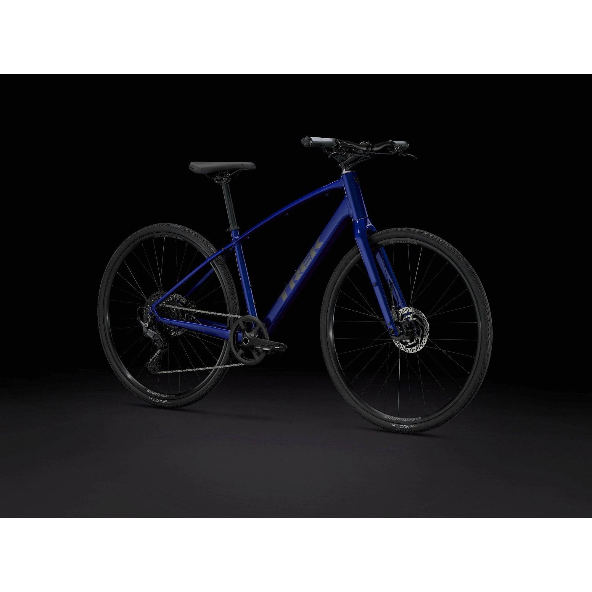 Trek FX 3 Hybrid Bike 2025, versatile commuter and fitness bicycle, black frame with gear shifters and comfortable saddle.