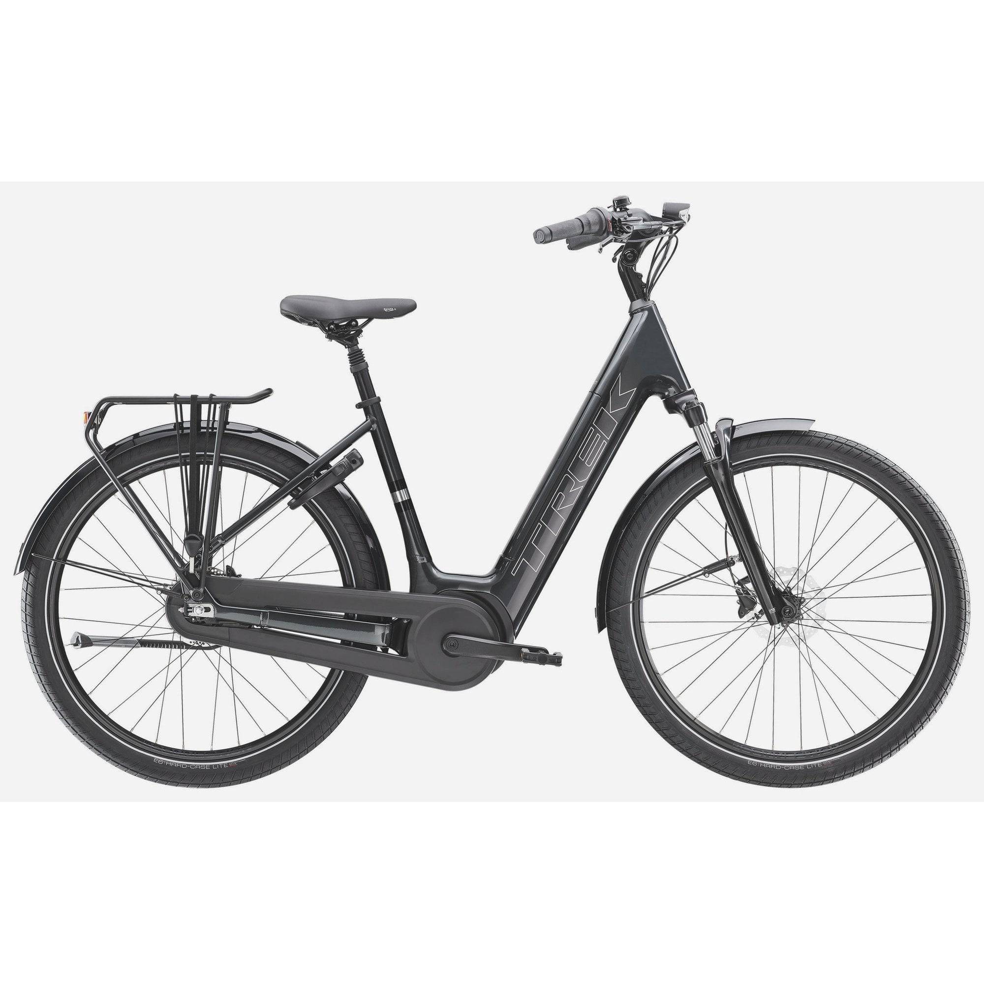 Trek District+ 3 lowstep e-hybrid bike for urban commuting and light trails with sleek frame and electric assist in a city setting.