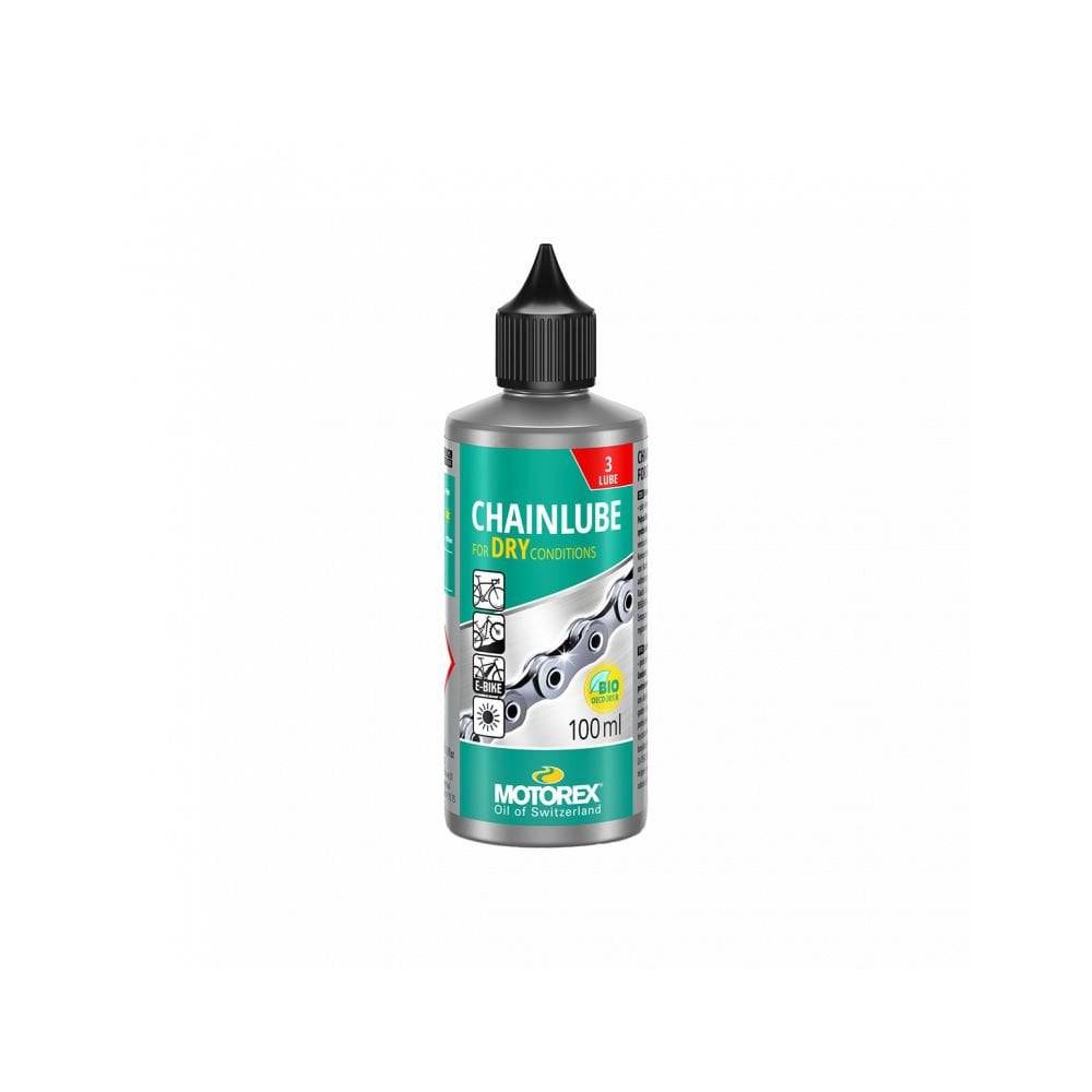 Motorex Chainlube Dry Conditions 100ml synthetic bike chain lubricant with PTFE, shown in a workshop setting.