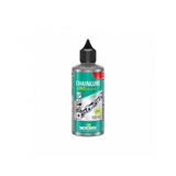 Motorex Chainlube Dry Conditions 100ml synthetic bike chain lubricant with PTFE, shown in a workshop setting.