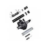Crankbrothers BC18 SOS Bottle Cage Tool Kit with multi-tool in black and silver, displayed in a workshop setting.