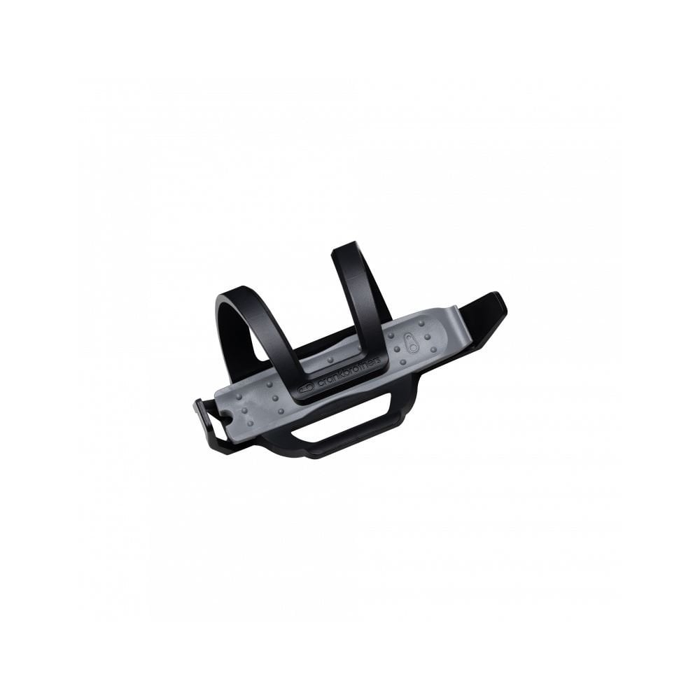 Crankbrothers BC2 SOS Bottle Cage with integrated tyre repair tools in black and silver, mounted on a workshop workbench.
