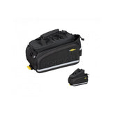 Topeak MTX TrunkBag DX 2.0 in black attached to bike rack, showing multiple compartments and reflective safety features.