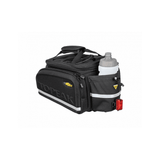 Topeak MTX TrunkBag DX 2.0 black bike rack bag with multiple compartments and reflective safety features, mounted on a bike.