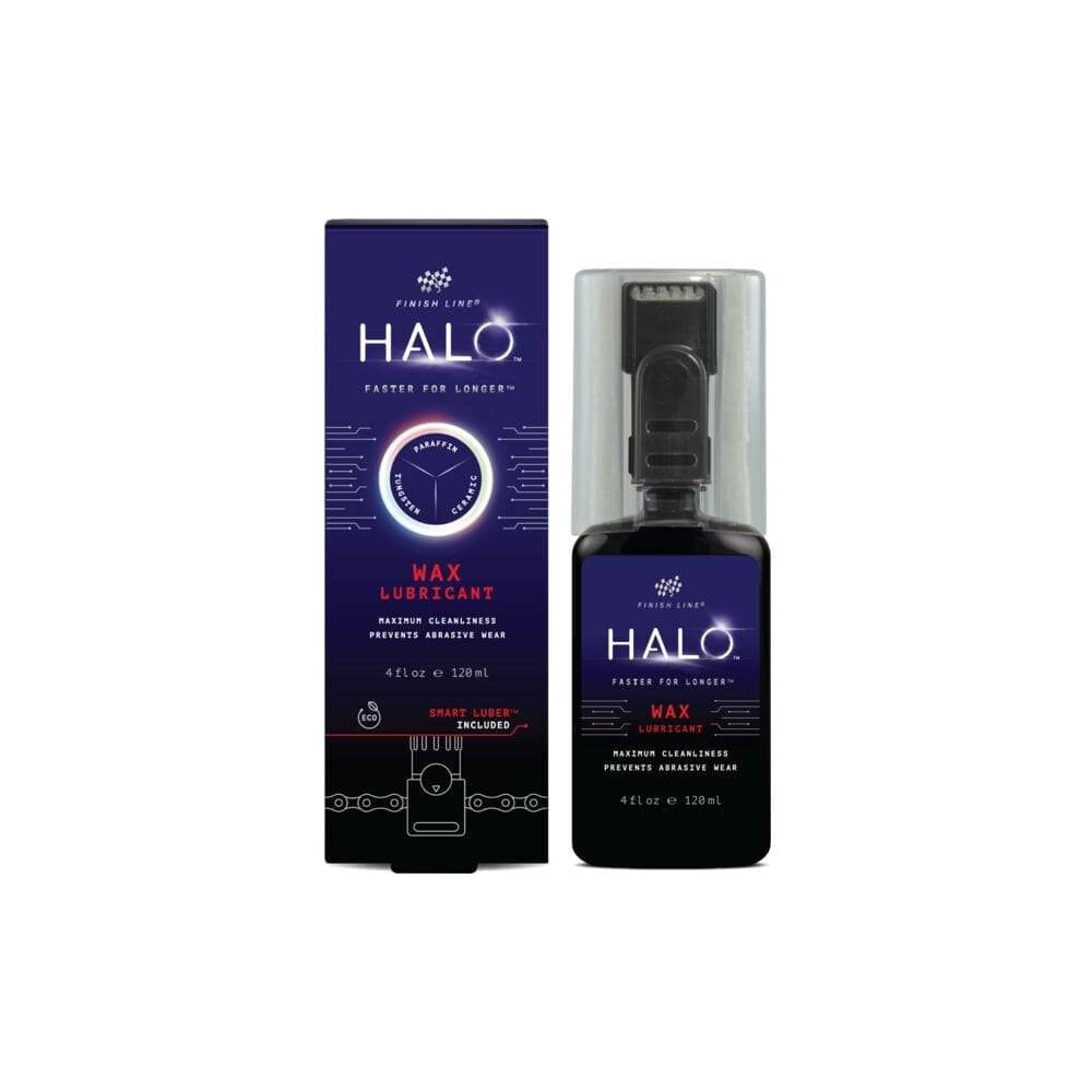Finish Line Halo Wax bicycle chain lubricant with Smart Luber for drivetrain maintenance, shown in workshop setting.