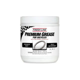 Finish Line Premium Ceramic Tech Grease tube for high-performance bike lubrication, shown in a workshop setting.