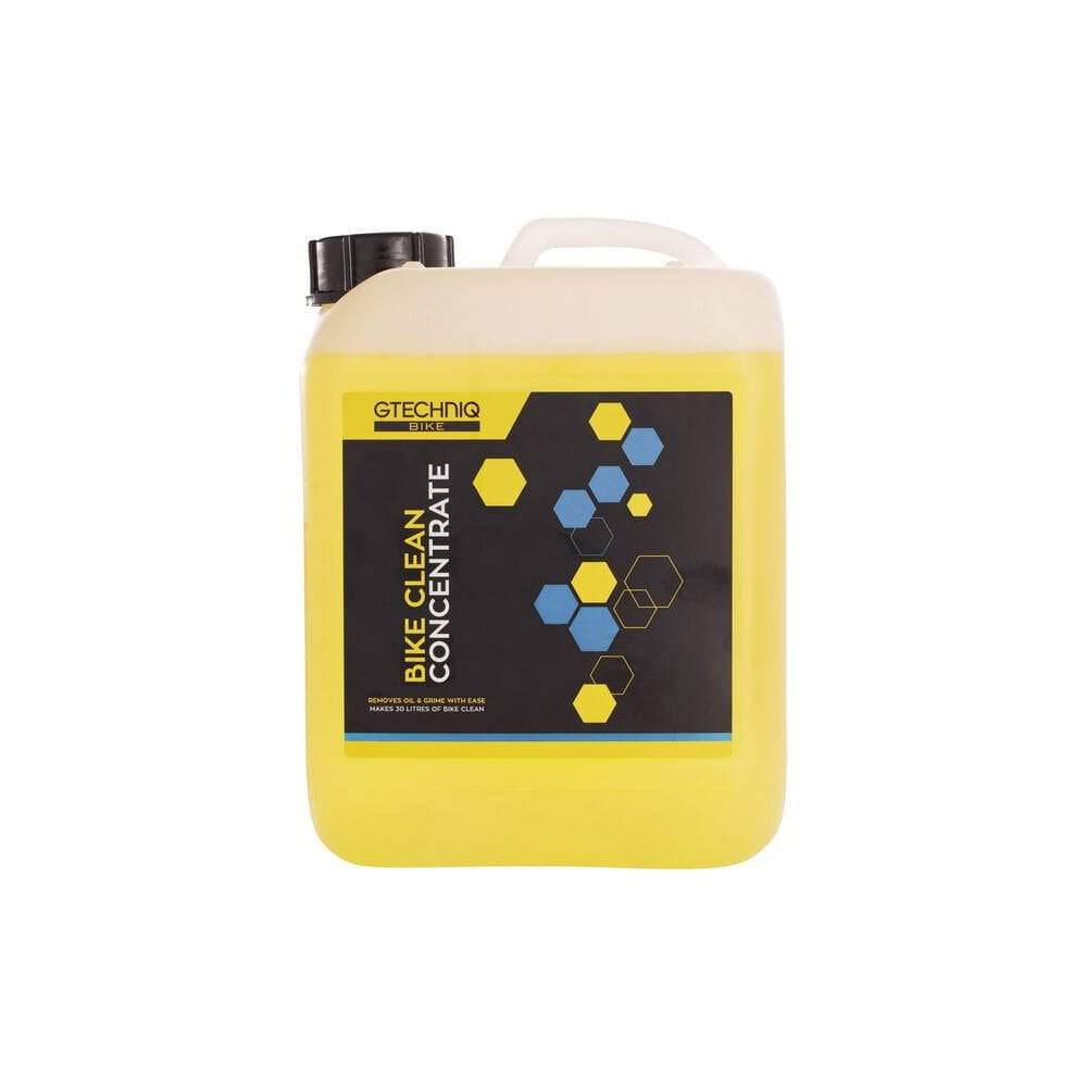Gtechniq Bike Clean Concentrate eco-friendly bike cleaner in a workshop setting, showing the bottle and cleaning tools.