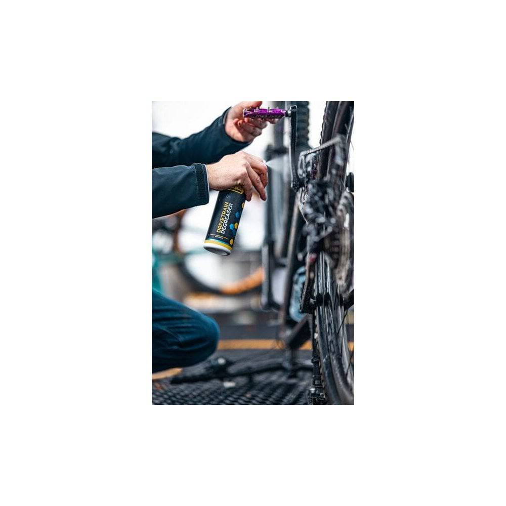 Gtechniq Bike Drivetrain Degreaser biodegradable cleaner applied to a bike chain and cassette in a workshop setting