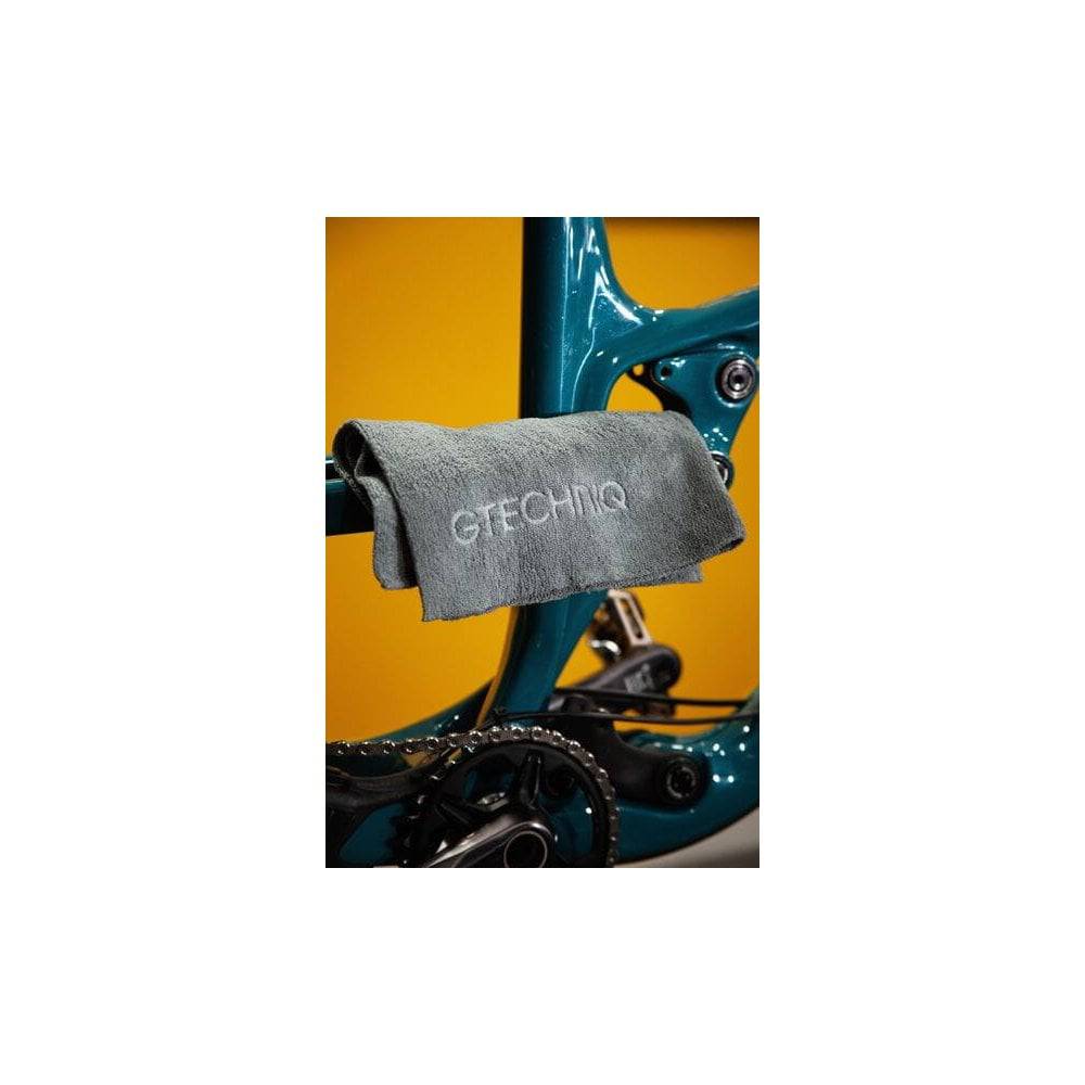Gtechniq Bike Premium Microfibre Cloth Triple Pack for bike cleaning and maintenance, shown in workshop setting