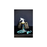 Gtechniq Bike Tri-Clean 500ml antibacterial cleaner for cycling gear and helmets, shown in a workshop setting.
