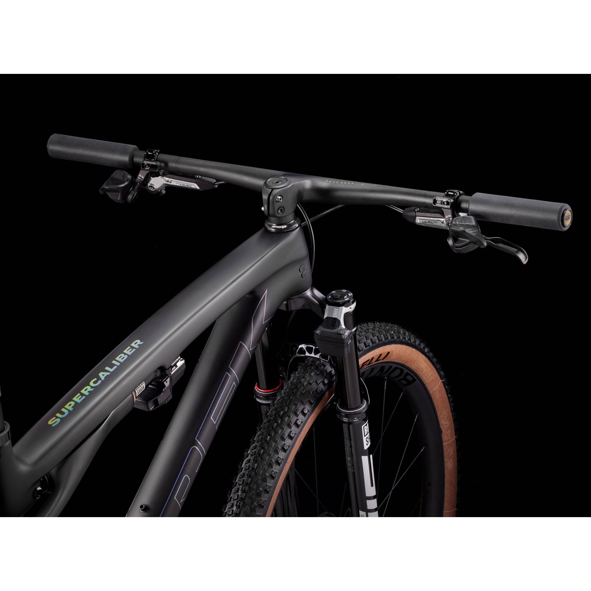 Trek Supercaliber SLR 9.9 Flight Attendant Gen 2 mountain bike for XC racing, black and green frame, front suspension, and racing tires