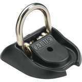 ABUS GRANIT WBA 100 wall anchor in hardened steel for bike security, mounted on a wall, accessory for securing bicycles