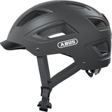 ABUS Hyban 2.0 urban cycling helmet with ventilation and adjustable fit, shown on a model outdoors.