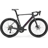 Merida Reacto 9000 Aero Road Bike with hydraulic disc brakes and wide tire compatibility, featuring a sleek aerodynamic frame.