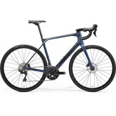 Merida Scultura Endurance 4000 road bike with hydraulic disc brakes and wide tire clearance up to 35c, black and red frame.