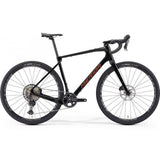 Merida Silex 7000 gravel bike with Shimano GRX 822 components and hydraulic disc brakes, showcasing the bike's frame and wheel details.