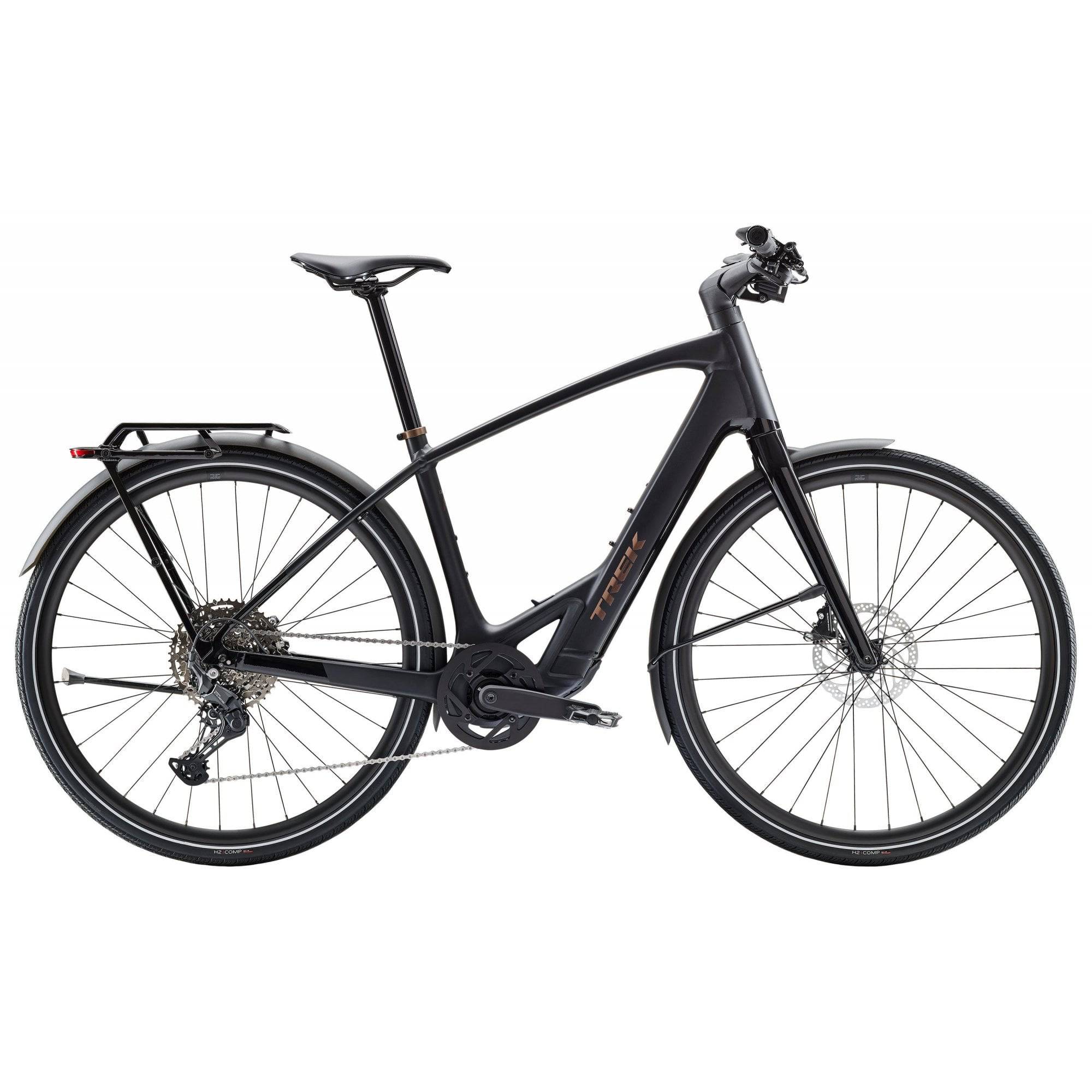 Trek FX+ 7 2025 e-hybrid bike with Shimano CUES U6000 system and disc brakes, shown from side view on a city street.