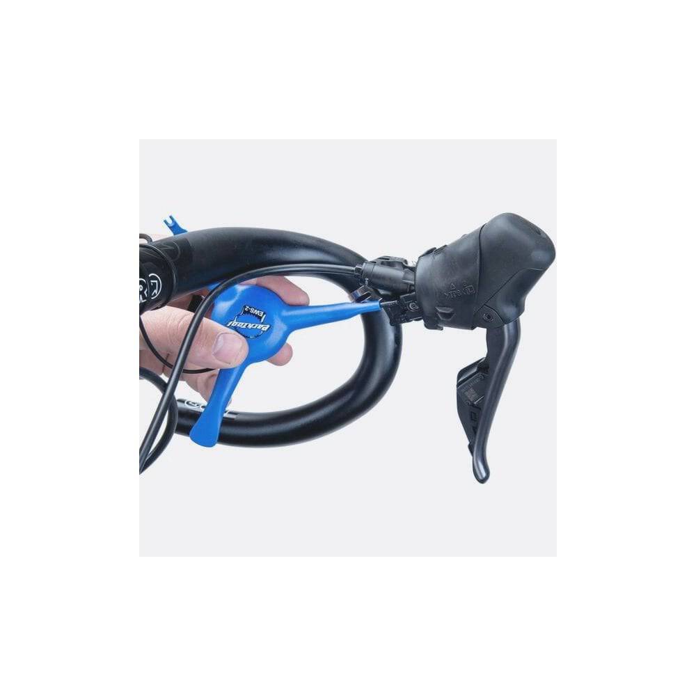 Park Tool EWS-2 electronic wire 3-way tool for Shimano Di2 and SRAM battery covers, used in bike workshop settings.