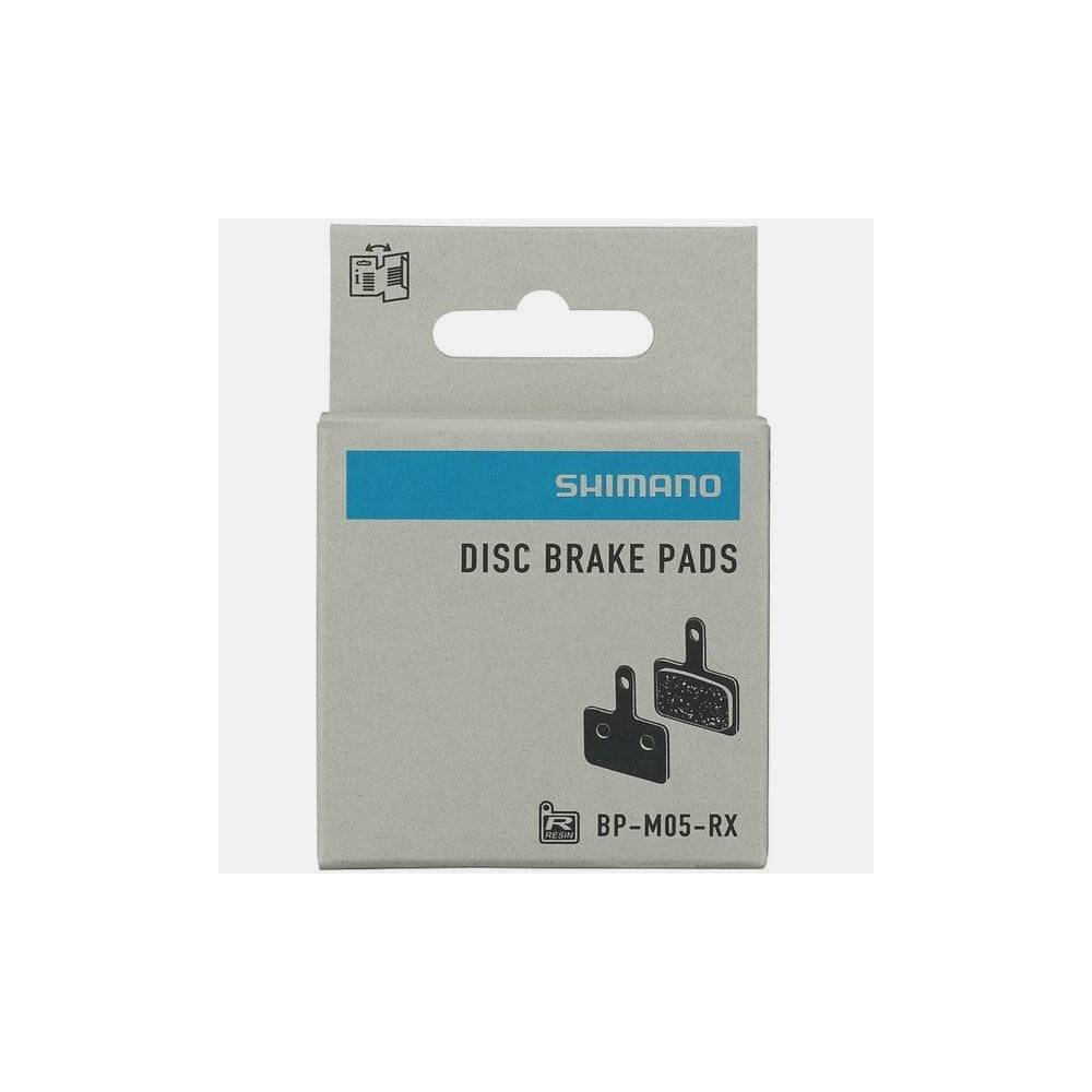 Shimano M05-RX resin disc brake pads with steel back plate for 2 piston bike brakes, close-up of brake pad components.