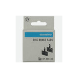 Shimano M05-RX resin disc brake pads with steel back plate for 2 piston bike brakes, close-up of brake pad components.