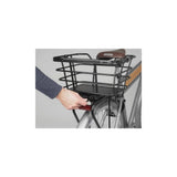 AtranVelo AVS PREMIUM UNI adapter for securing bike bags and baskets, shown attached to a bicycle rack.