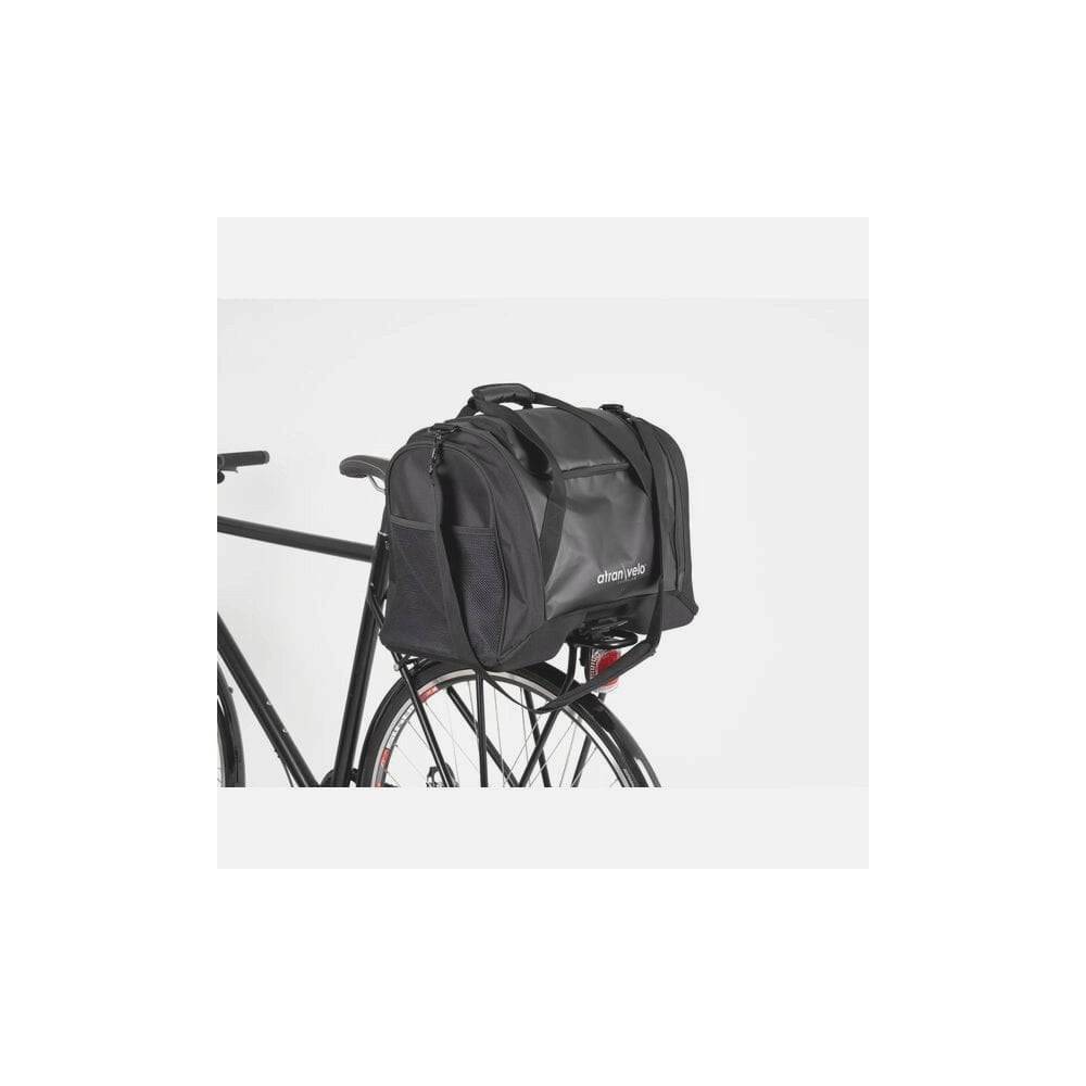 AtranVelo PULSE AVS 36L black duffle bag with AVS mounting system for bike accessories, shown from side view.