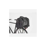 AtranVelo PULSE AVS 36L black duffle bag with AVS mounting system for bike accessories, shown from side view.