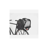 AtranVelo PULSE AVS 36L black reflective duffle bag with AVS mounting system, showing its rugged, spacious design and reflective features.