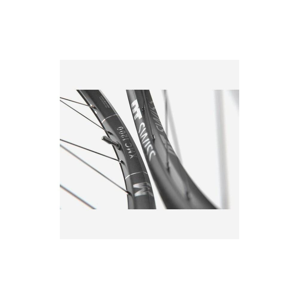 DT Swiss XMC 1200 29-inch front mountain bike wheel with 30mm carbon rim and BOOST axle, showcasing sleek bike component design.