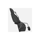 Thule Yepp Nexxt 2 Maxi child bike seat frame mount with suspension and safety buckle, outdoor setup for children.