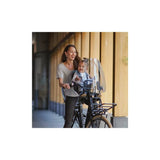 Urban Iki TA-KE front child bike seat showing weather-resistant design and safety features on a bicycle.