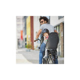 Urban Iki TA-KE rear child seat mounted on e-bike frame, showing secure attachment and comfortable seating for kids.