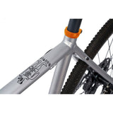 Cinelli Zydeco Silver Bootleg gravel bike with front rack for urban commuting and mixed terrain riding.