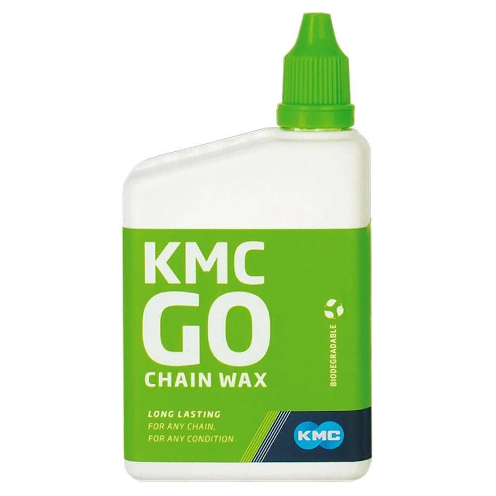 KMC GO Chain Wax Lube for dry bike chains, workshop scene showing lubricant application on a bicycle drivetrain.