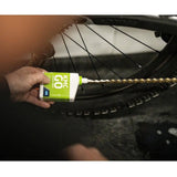 KMC GO Chain Wax Lube in a workshop setting, dry bike chain lubricant for drivetrain protection, showing the product container and application area.