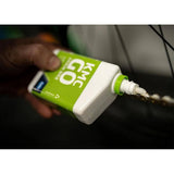 KMC GO Chain Wax Lube for dry bike chains, showcasing a container of lubricant used for drivetrain protection in a workshop setting.