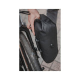 Black Topeak QR Fork Drybag 5.8L waterproof bikepacking bag attached to a bike fork with bolt-on mounting system.