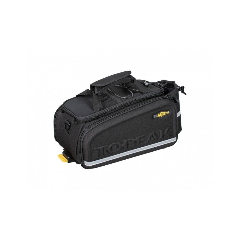 Topeak MTX TrunkBag EXP black bike rack bag with quick-release system and expandable design, mounted on a bicycle.