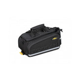 Topeak MTX TrunkBag EXP black bike rack bag with quick-release system and expandable design, mounted on a bicycle.