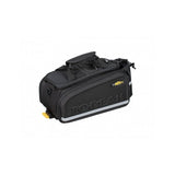 Topeak MTX TrunkBag EXP black bike rack bag with quick-release system and expandable design, mounted on a bicycle.