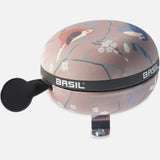 Basil Wanderlust Big Bicycle Bell 80mm Orchid Rose with bird print, a colorful bike accessory for safety and style