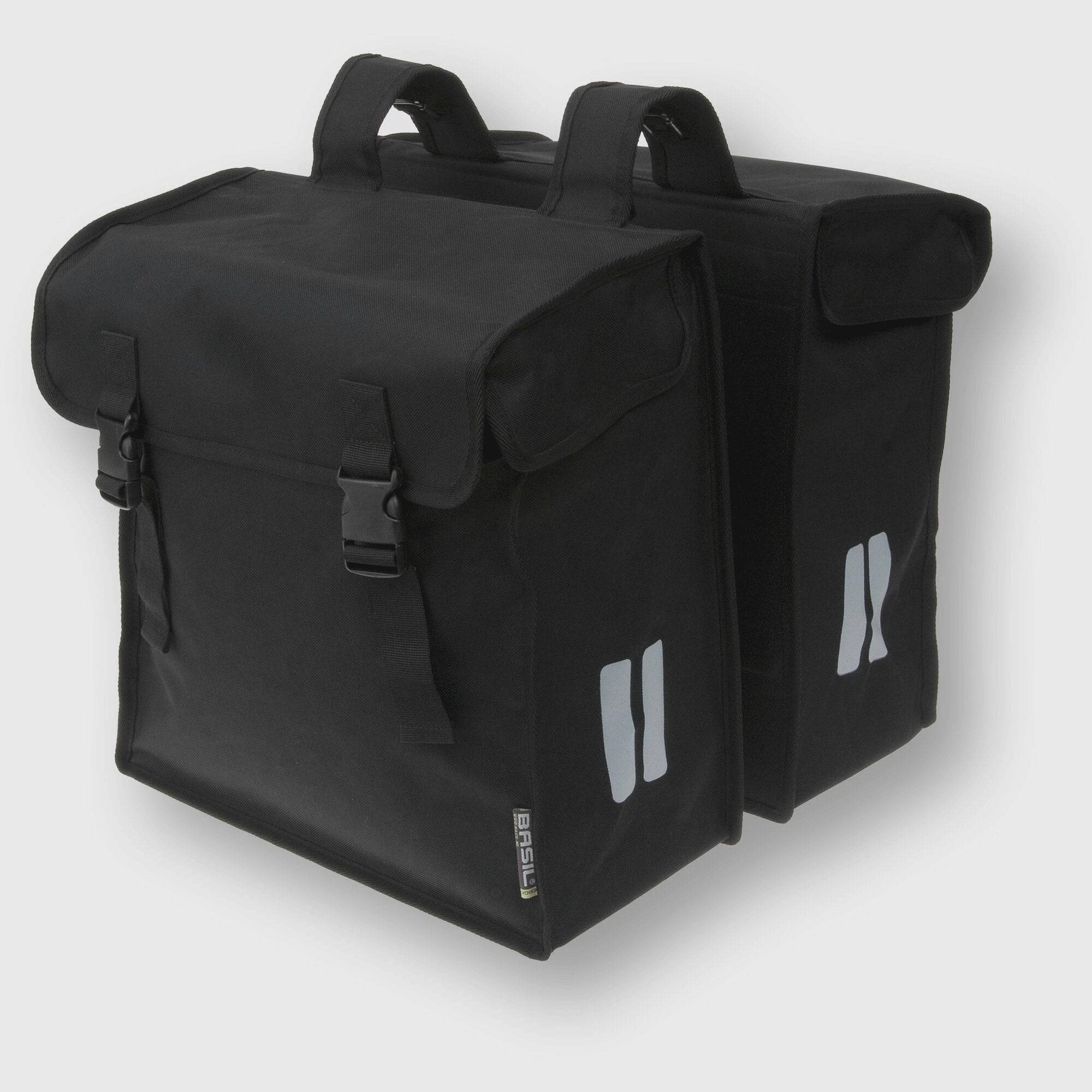 Basil Mara XXL black double bike bag with water-repellent material and reflective strips, mounted on a bicycle pannier rack.