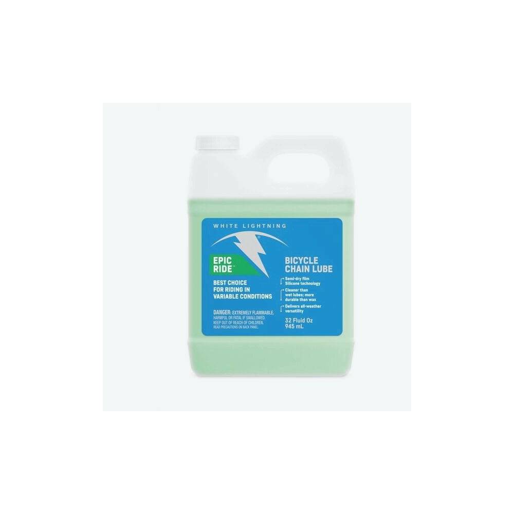 White Lightning Epic Ride synthetic chain lube bottle with bike workshop tools and chain cleaning supplies, long-lasting bike lubricant.