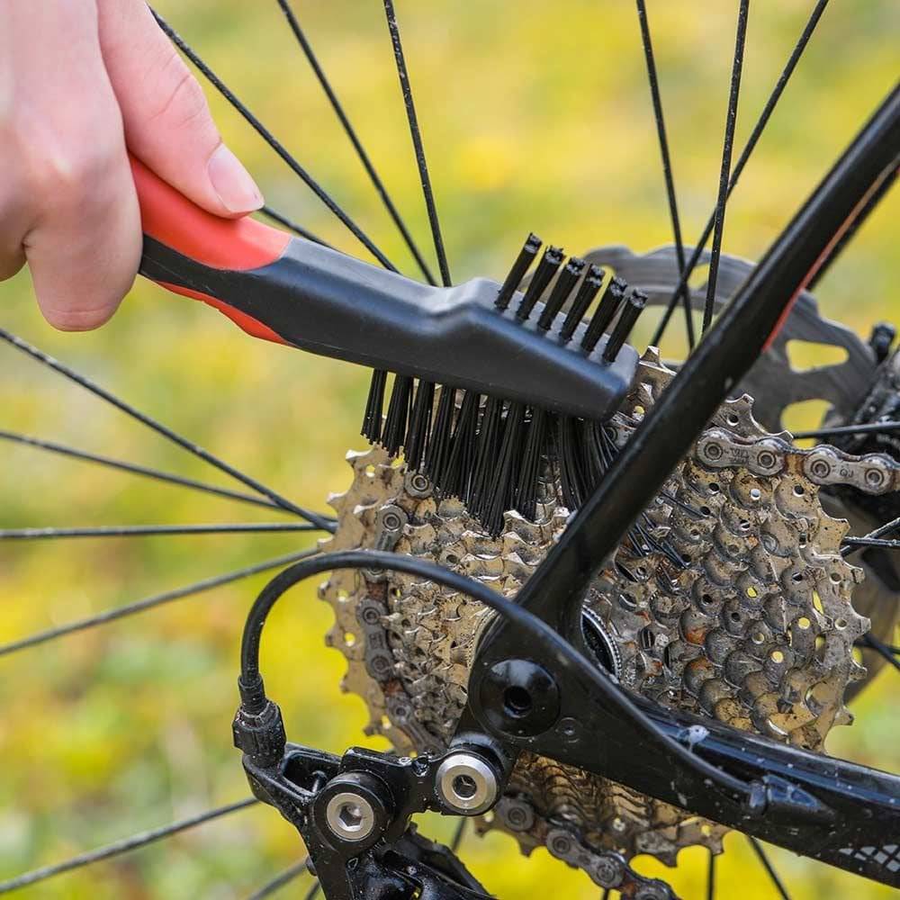 Zefal ZB Brush Set for bike cleaning, including brushes for wheels, chains, and frames, arranged on a workshop surface.