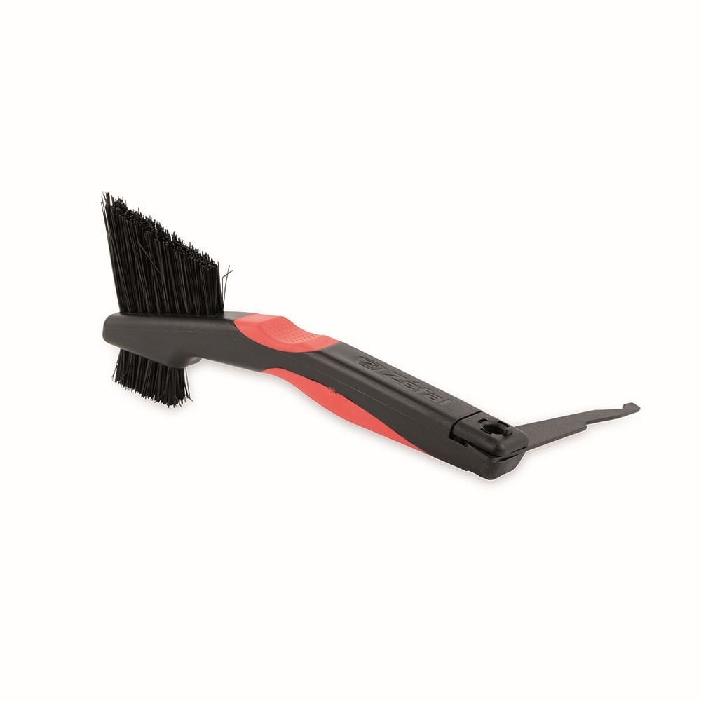 Zefal Clean Brush 3-in-1 bike cleaning tool for chain, freewheel, and derailleur on workshop workbench.