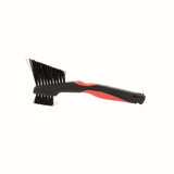 Zefal Clean Brush 3-in-1 bike cleaning tool for chain, freewheel, and derailleur, shown in a workshop setting.