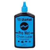 Zefal Pro Wet Lube biodegradable bike lubricant in a workshop setting, designed for wet weather protection on bicycle chains.