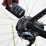 Zefal Pro Wet Lube biodegradable bike lubricant in a workshop setting, designed for wet weather protection on bikes.