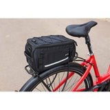 Zefal Z Traveller 40 bike rack bag with waterproof cover and reflective strips, mounted on a bicycle for accessories storage.