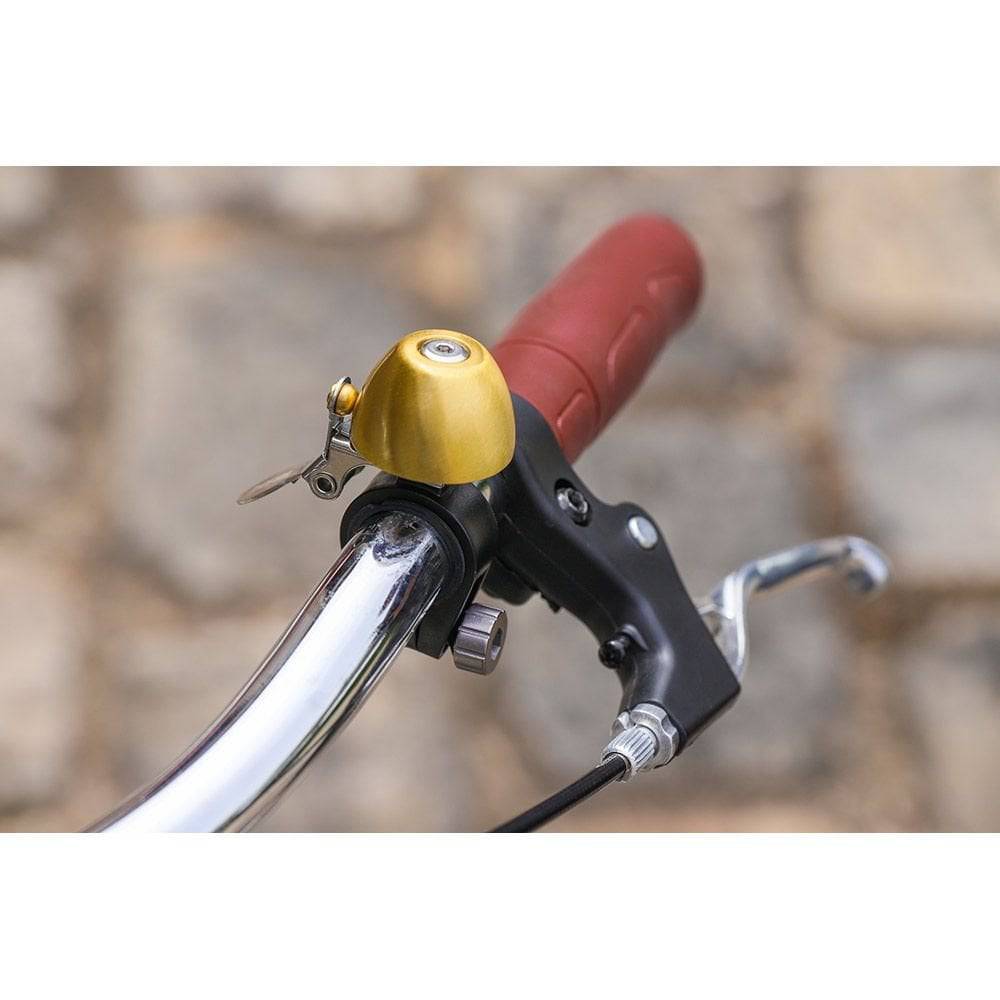 Zefal Classic Brass Bike Bell with loud chime, easy installation, mounted on a bicycle handlebar for cycling safety accessory.